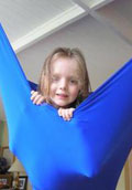 girl hangs out in a lycra swing