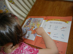 A child using a hidden picture book to practive Visual Processing skills