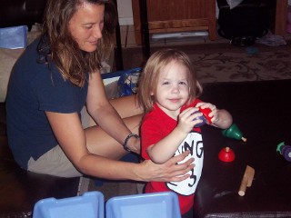 A small girl receiving Cranial Sacral Therapy