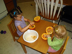 scooping out pumpkins to provide tactile experience